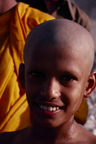 Sri Lanka, Arambegama, Portrait of young novice monk after having had his head shaved during ordination ceremony.