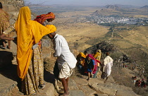 India, Rajasthan, Religion, Pilgrims climbing steps set into steep hillside to religious site above Pushkar.