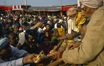 India, West Bengal, Sagar Island, Crowds of pilgrims bringing offerings to Kapil Muni temple during Sagar Festival. .