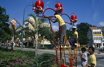 Singapore, Chinatown, Chinese New Year. Chineses lanterns being put up in Eu Tong Street .