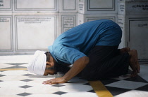 India, Punjab, Amritsar, Sikh man praying inside the Golden Temple. .