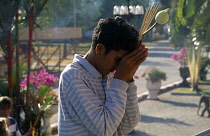 Thailand, Phuket, Man Praying.