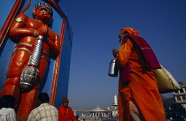 India, Maharashtra, Nasik, Sadhu or holy man praying at Hanuman Shrine.