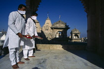 India, Gujarat, Palitana, Jain pilgrims with offerings of flowers at Shatrunjaya or Place of Victory hilltop temple complex and historic Jain pilgimage site.