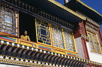 India, West Bengal, Darjeeling, Monk at window of Bhutia Busty monastery.