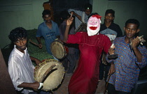 India, Kerala, Cochin, Christmas celebrations group of young men with musical instruments carol singing and acting short dramas.