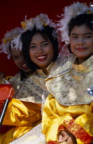 Thailand, North, Chiang Mai, Chinese New Year.  Three smiling young women in costume on processional float.