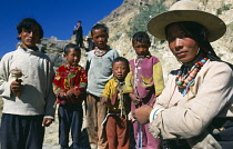 China, Tibet, Shigatse, Family of pilgrims stood on the Tashilhunpo Kora or pilgrims way.