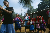 Thailand, North, Baan Mai Suai, Lisu new year celebrations,  Musician women and children in traditional dress.