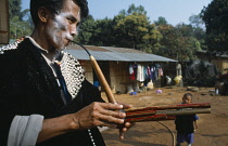 Thailand, North, Baan Mai Suai, Lisu new year celebrations,  Musician in traditional dress.