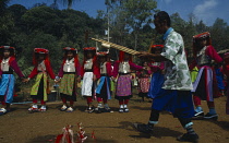 Thailand, North, Baan Mai Suai, Lisu new year celebrations,  Musician and children dancing wearing traditional costume.