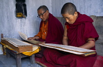 India, Bihar, Bodhgaya, Two Buddhist monks reading scriptures.