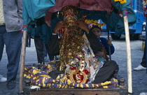 India, Religion, Wedding, Groom wearing head-dress covered with money sitting under canopy at rural Hindu wedding.