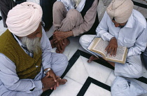 India, Punjab, Amritsar, Reading Holy book.
