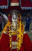 India, Himachal Pradesh, Kulu, Figure of temple god garlanded with flowers during Hindu Dussehra festival.
