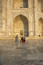 India, Uttar Pradesh, Agra, Partial view of the exterior of the Taj Mahal  Family in foreground making pilgrimage.