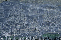 Nepal, Annapurna Region, Stone engraved with mantra and Buddhist deities.