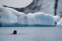 Iceland, Jokulsarlon Island, Swimmer in glacial lagoon.