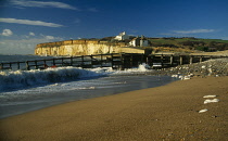 England, East Sussex, Seven Sisters, Cuckmere Haven, View along coastline towards chalk cliff and two hundred year old coastguard cottages built on top of the cliffs.