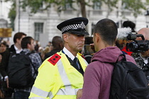 England, London, Westminster, Brexit demonstrations, protestor recording policeman with mobile phone.