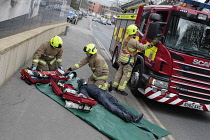 England, Kent, Sevenoaks, Fire and Rescue team on training exercise, recovered dummy person being given oxygen.