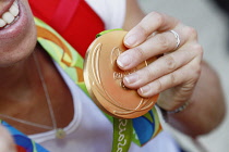 Sport, Olympics, Athlete holding gold medal from Rio games 2016.