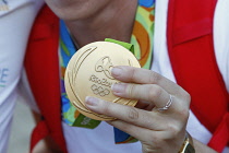 Sport, Olympics, Athlete holding gold medal from Rio games 2016.