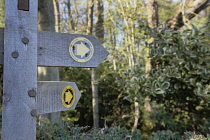 England, East Sussex, Wooden public bridleway sign in the countryside.