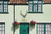 England, Somerset, Dunster, Detail of the colourful facade of the Stags Head Inn.