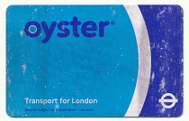 England, London, Old scuffed and well used TFL Oyster pre pay travel card. **Editorial Use Only**