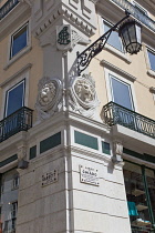 Portugal, Estremadura, Lisbon, Chiado, Ornate street lamp fixed to corner building on Rua Garrett.