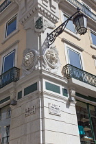 Portugal, Estremadura, Lisbon, Chiado, Ornate street lamp fixed to corner building on Rua Garrett.