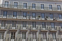Portugal, Estremadura, Lisbon, Bairro Alto, Typical apartment building with tiled exterior, balconies and french windows.
