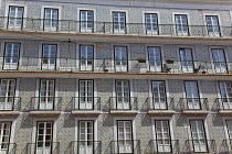 Portugal, Estremadura, Lisbon, Bairro Alto, Typical apartment building with tiled exterior, balconies and french windows.