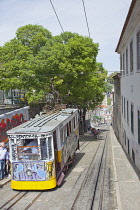Portugal, Estremadura, Lisbon, Bairro Alto, Elevador da Gloria, Funicular railway tram covered in graffiti.