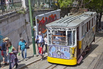 Portugal, Estremadura, Lisbon, Bairro Alto, Elevador da Gloria, Funicular railway tram covered in graffiti.