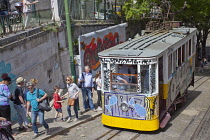 Portugal, Estremadura, Lisbon, Bairro Alto, Elevador da Gloria, Funicular railway tram covered in graffiti.