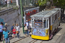 Portugal, Estremadura, Lisbon, Bairro Alto, Elevador da Gloria, Funicular railway tram covered in graffiti.