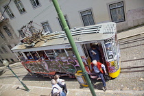 Portugal, Estremadura, Lisbon, Bairro Alto, Elevador da Gloria, Funicular railway tram covered in graffiti.