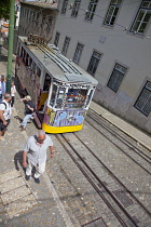 Portugal, Estremadura, Lisbon, Bairro Alto, Elevador da Gloria, Funicular railway tram covered in graffiti.