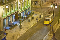 Portugal, Estredmadura, Lisbon, Baixa, Praca da Figueira, Tram parked at night.