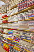 Portugal, Estremadura, Lisbon, Baixa district, Display of various fabrics for sale.