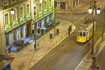 Portugal, Estredmadura, Lisbon, Baixa, Praca da Figueira, Tram parked at night.