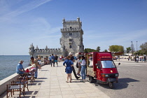 Portugal, Estredmadura, Lisbon, Belem, Torre de Belem built as fortress between 1515-152, Tuk Tuk selling wine to toursts.