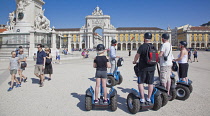 Portugal, Estremadura, Lisbon, Baixa, Praca do Comercio, Segway guided tour of the square with equestrian statue of King Jose and Rua Augusta triumphal arch.