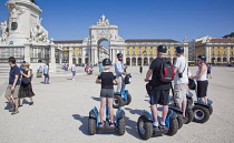 Portugal, Estremadura, Lisbon, Baixa, Praca do Comercio, Segway guided tour of the square with equestrian statue of King Jose and Rua Augusta triumphal arch.