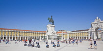 Portugal, Estremadura, Lisbon, Baixa, Praca do Comercio, Segway guided tour of the square with equestrian statue of King Jose and Rua Augusta triumphal arch.