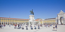 Portugal, Estremadura, Lisbon, Baixa, Praca do Comercio, Segway guided tour of the square with equestrian statue of King Jose and Rua Augusta triumphal arch.