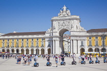 Portugal, Estremadura, Lisbon, Baixa, Praca do Comercio, Segway guided tour of the square with equestrian statue of King Jose and Rua Augusta triumphal arch.