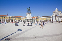 Portugal, Estremadura, Lisbon, Baixa, Praca do Comercio, Segway guided tour of the square with equestrian statue of King Jose and Rua Augusta triumphal arch.